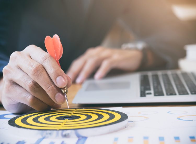 Businessman holding red dart push on target. Business strategy planning success target goals. Business development concept